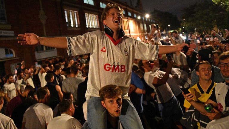 Fulham fans celebrate outside the team&#39;s Craven Cottage ground