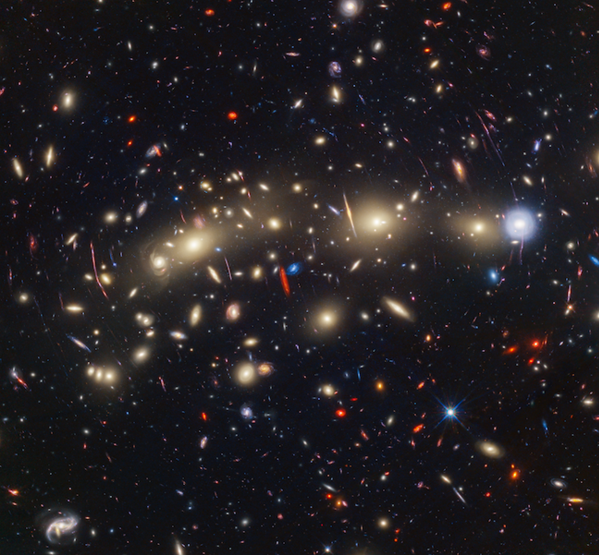 At center is an expansive collection of galaxies in the galaxy cluster MACS0416.