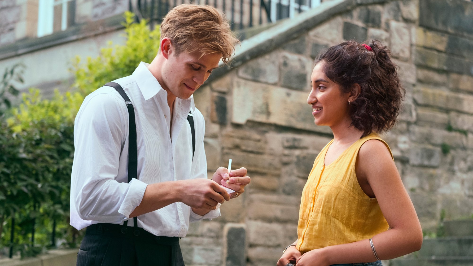 A young man and woman trade numbers at Edinburgh University.