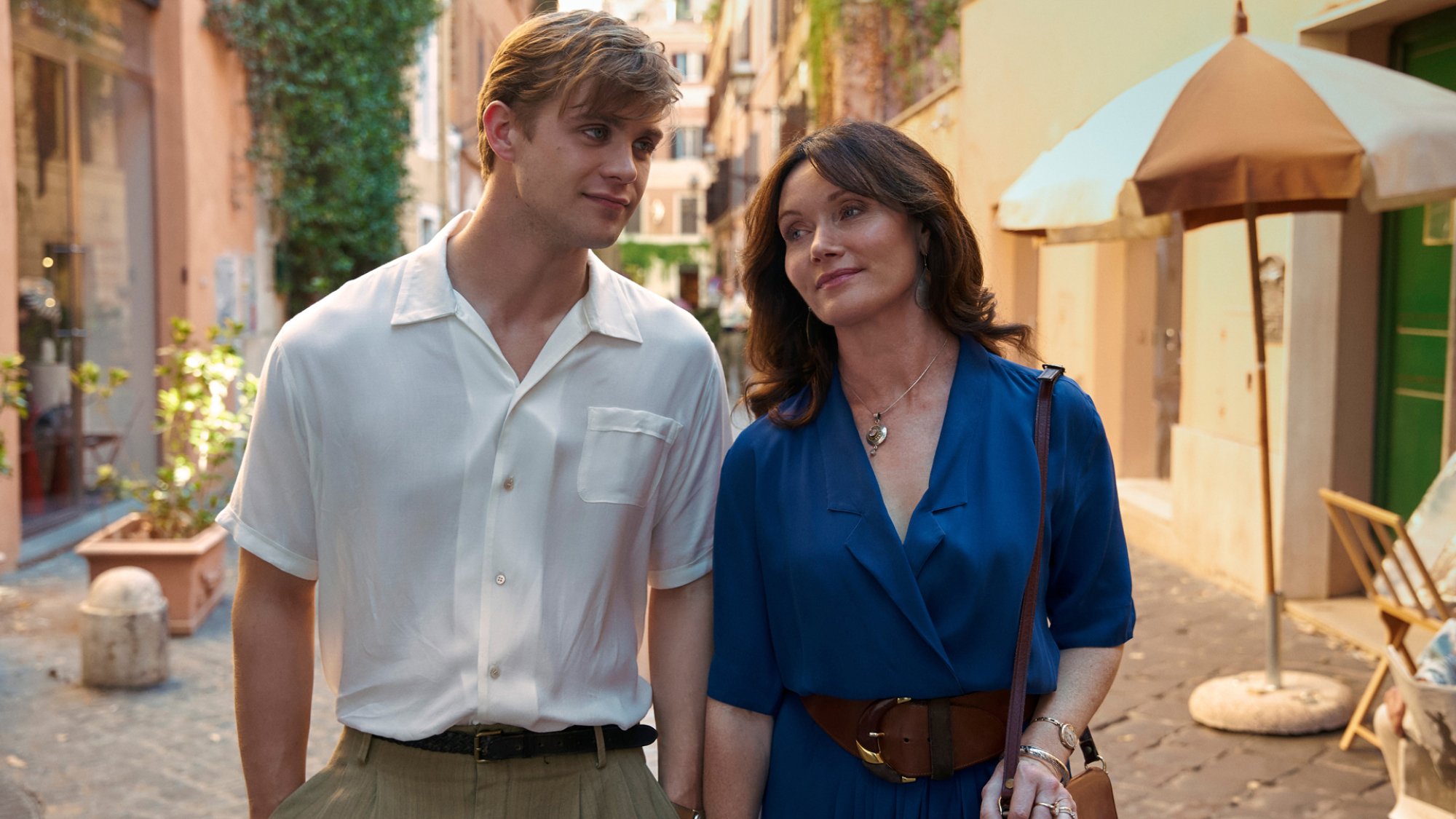 A young man and his mother stroll through Florence.