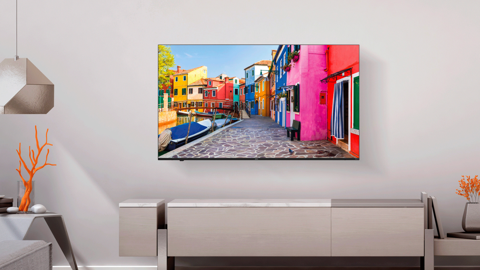 a 65-inch onn. qled tv mounted on a wall above a light gray console in a modern room