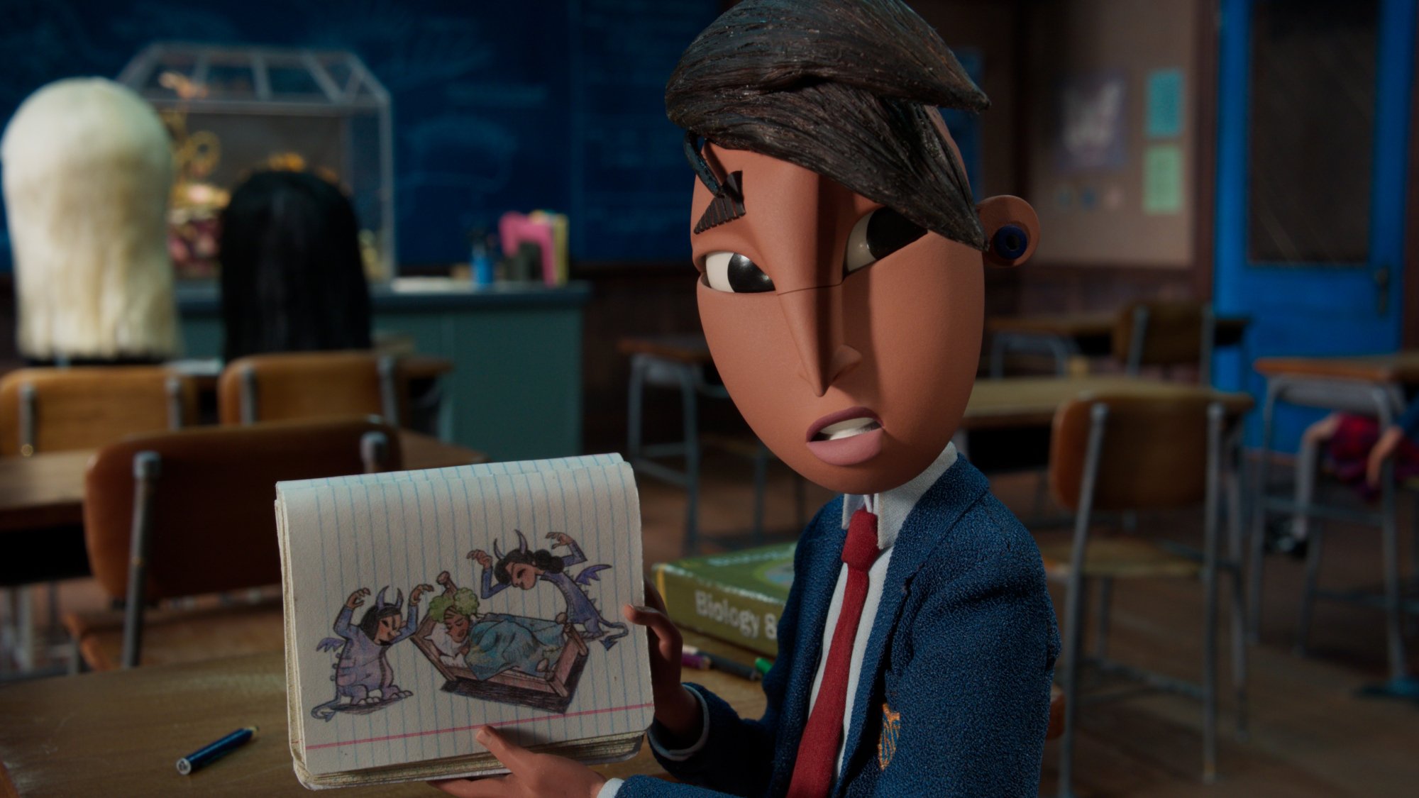 Animated boy holds up a picture of a drawing in a classroom.