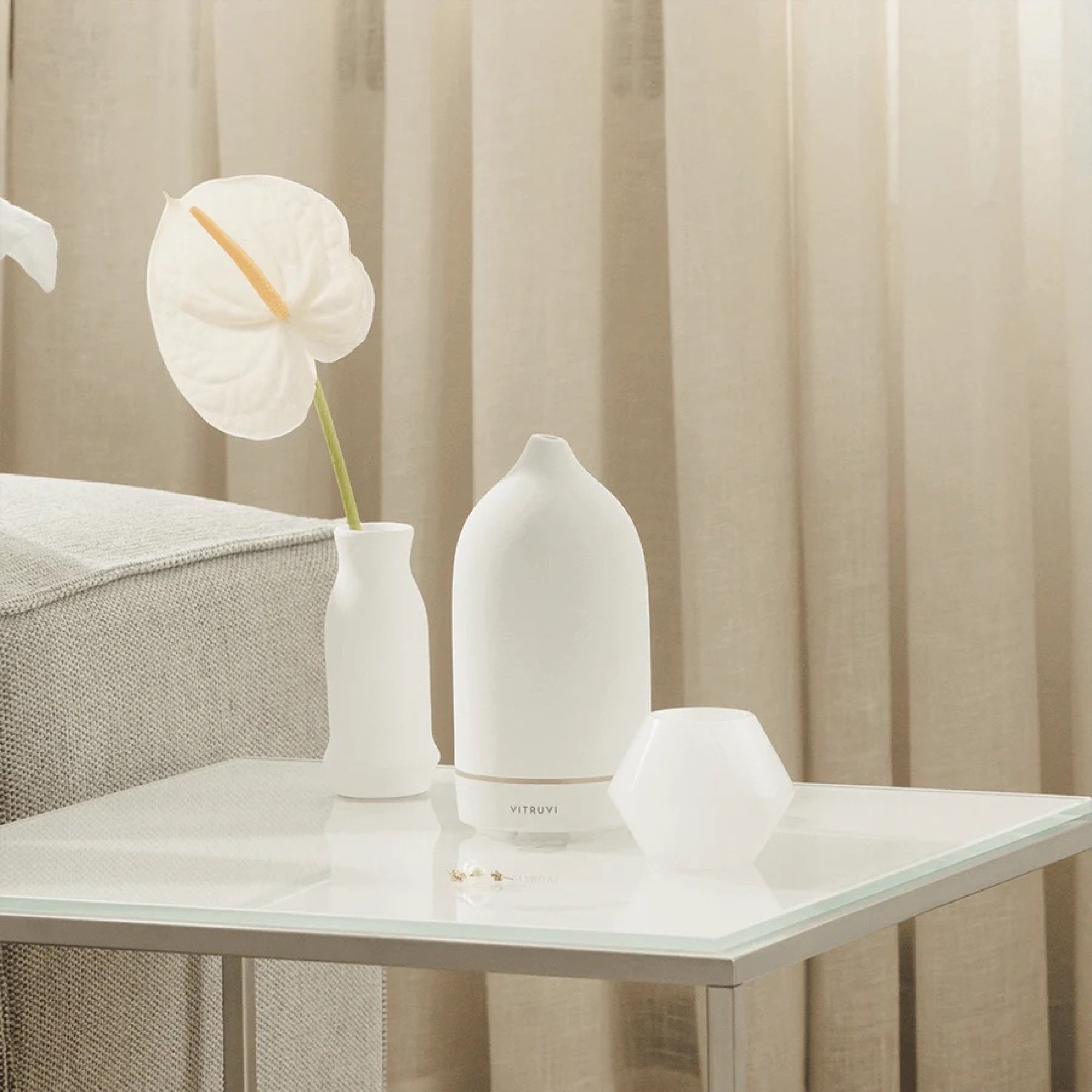Vitruvi oil diffuser sitting on a side table