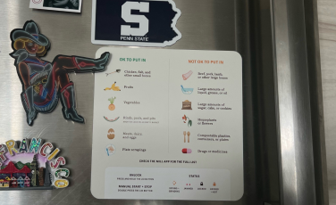 Fridge door with several magnets including list of food that can be put in bin